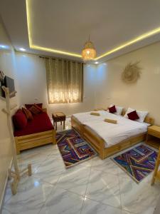 a bedroom with two beds and a couch in it at Atlantic Coast Imsouane in Imsouane