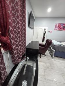 a room with a desk and a bed and a mirror at Newly built Studio in Irvington