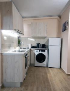 a kitchen with a white refrigerator and a dishwasher at Maria's Sweet Home in Chios +10 photos