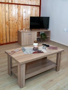 a wooden coffee table in a living room with a tv at Maria's Sweet Home in Chios