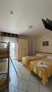 a bedroom with two beds in a room at Hotel Gattei in Rimini