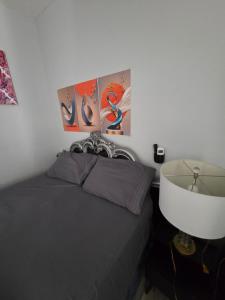 a bedroom with a bed and a white wall at Newly built Studio in Irvington