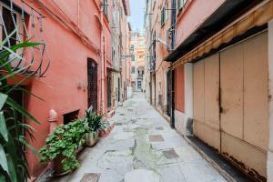 an alley with plants on the side of buildings at Sole Mio in Sanremo