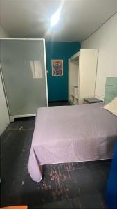 a bedroom with a purple bed in a room at BluePepper City Hostel in Guadalajara