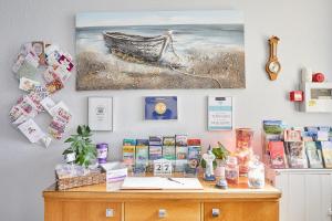 a desk with a picture of a boat on a wall at The Tennyson in Bridlington