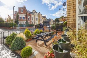 a bench in a garden in front of a building at The Tennyson in Bridlington