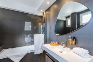 a bathroom with a sink and a mirror at Hotel Vauban Briançon Serre Chevalier in Briançon
