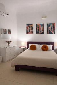 a bedroom with a bed with two pillows on it at Atenè Rooms in Agrigento
