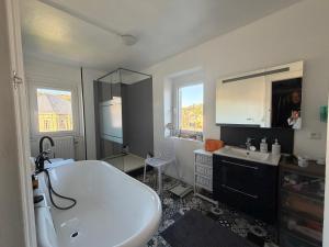 a bathroom with a large white tub and a sink at VILLA des Peintres in Étretat +60 photos