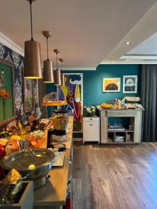 a kitchen with blue walls and a counter with food at Moselina Ferienwohnungen in Sankt Aldegund