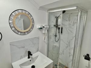 a white bathroom with a sink and a shower at Al Mare Ocean View in Albufeira