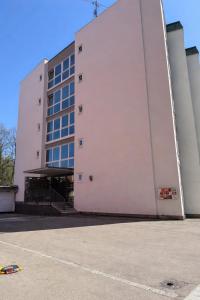 a large white building with a parking lot in front of it at Black & Yellow Studio in Augsburg