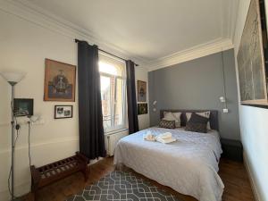 a bedroom with a bed and a window at VILLA des Peintres in Étretat