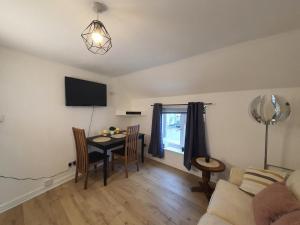 a living room with a table and a couch at FLAT 2 Seven Cambrian Square First Floor Flat in Newtown