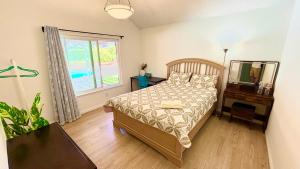a bedroom with a bed and a mirror and a window at Joshie home in Rancho Cucamonga