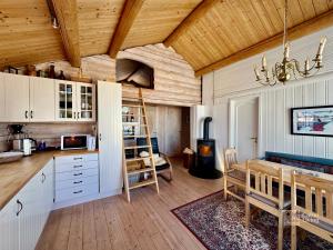 a kitchen and dining room with a wooden ceiling at Authentic mountain atmosphere at Sjusjøen in Ringsaker
