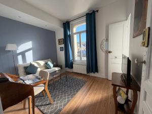a living room with a couch and a table at VILLA des Peintres in Étretat