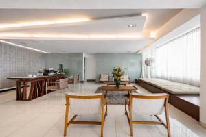 a living room with a table and chairs and a couch at Lincoln Suite in Santo Domingo