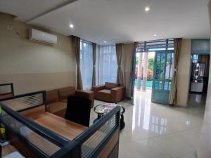 a living room with a couch and a table at Gosen Hotel Lubumbashi in Lubumbashi