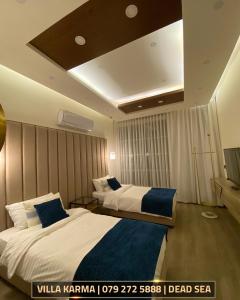 a hotel room with two beds and a tv at Villa karma in Al Rama +11 photos