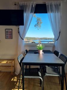 a dining room with a table and chairs and a window at Visitor Stugby in Håverud