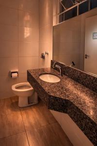 a bathroom with a sink and a toilet at Classik Prime Motel in Araçatuba