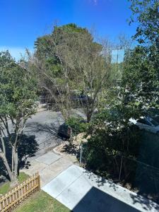 an aerial view of a parking lot with trees and a fence at Prytania Pearl - 3 Bedroom 2 Bathroom Home in New Orleans