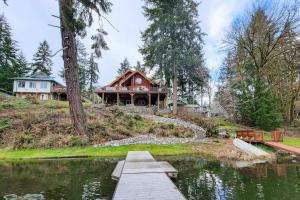 a house on a hill next to a lake at The Dockside Gamehouse in Olympia