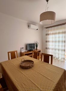 a room with a table with a basket on top of it at Albufeira Mar Vilas in Albufeira