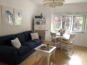 a living room with a blue couch and a table at La ballena de rayas in Tazones