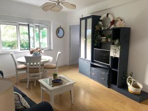 a living room with a table and a dining room at La ballena de rayas in Tazones +20 photos