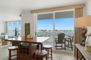 a kitchen and dining room with a view of the ocean at SeaSpray Riverside 312 in Perdido Key