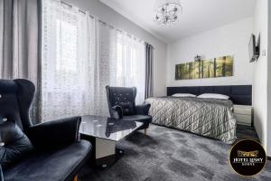 a bedroom with a bed and a table and a chair at Hotel Leśny Korne koło Kościerzyny - Kaszuby in Korne