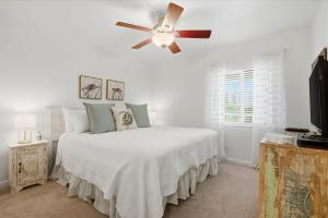 a white bedroom with a bed with a ceiling fan at SeaSpray Riverside 312 in Perdido Key +40 photos