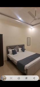 a bedroom with a large bed in a room at Badri Vishal in Varanasi