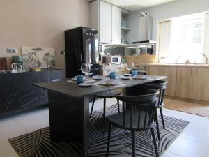 a kitchen with a table with wine glasses on it at Casa da Âncora in Viana do Castelo