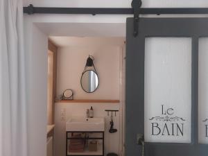 a bathroom with a white sink and a mirror at Gästehaus 22 am Klostergarten in Rehna +39 photos