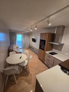 a kitchen and living room with a table and chairs at hotel Villa Gesell Spa in Villa Gesell
