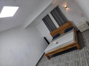 a small bed in a room with a window at The Palms Property in Long Mountain