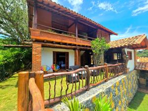 a wooden fence in front of a house at Cabañas el Nopal in San Gil