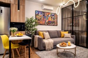 a living room with a couch and a table at Auezov City in Almaty