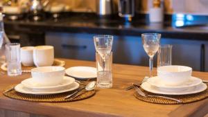 a wooden table with white plates and glasses and silverware at Uludağ Vadi Konakları in Bursa +22 photos