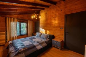 a bedroom with a bed in a room with wooden walls at Uludağ Vadi Konakları in Bursa
