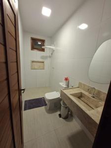 a bathroom with a sink and a toilet at Pousada Breizh Brasil Lençois - BBL in Barreirinhas