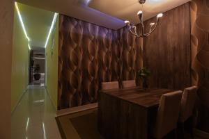 a dining room with a wooden table and a chandelier at Hotel Franco Blumenau in Blumenau +30 photos