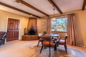 a dining room with a table and chairs and a fireplace at Tanque Verde Guest Ranch in Tucson