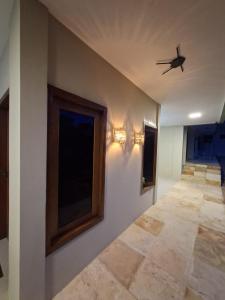 a hallway of a house with a ceiling fan at Pousada Breizh Brasil Lençois - BBL in Barreirinhas