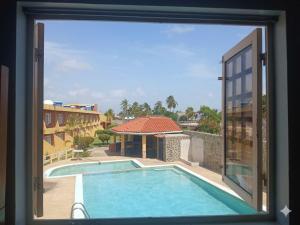 a view of a swimming pool from a window at Águila Marina Suites in Chichiriviche