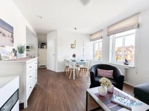 a living room with a couch and a table at Hus Krüüzpadd boben in Cuxhaven