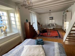 a bedroom with a bed and a living room at Clos Belin in Chavornay